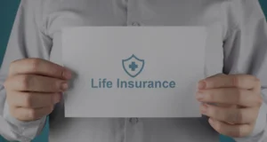 Person holding a sign with life insurance symbol to represent business protection